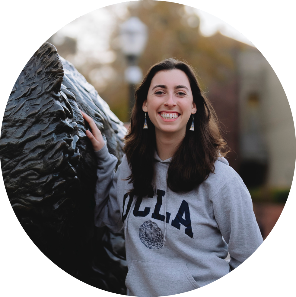 Girl smiling next to bruin bear