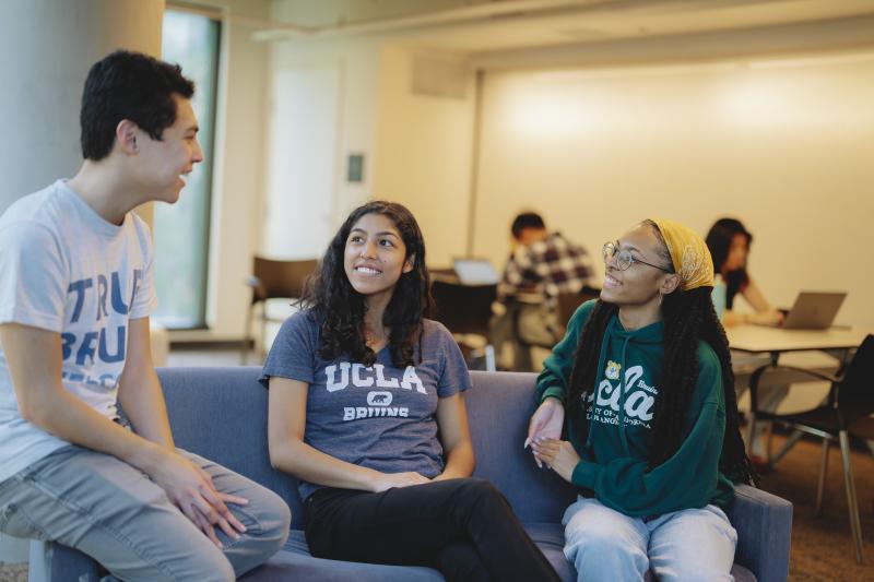 three students talking in a study lounge