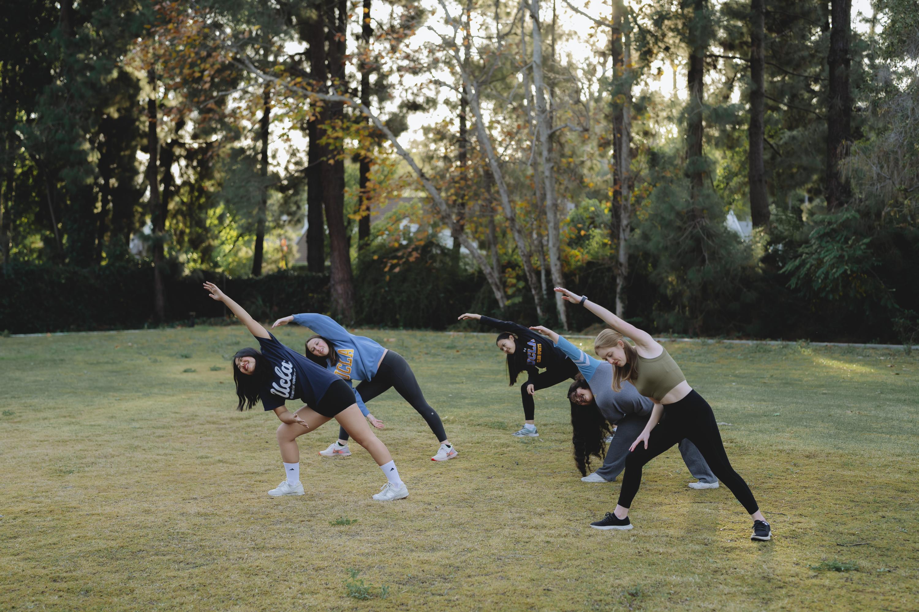 students stretching on a field