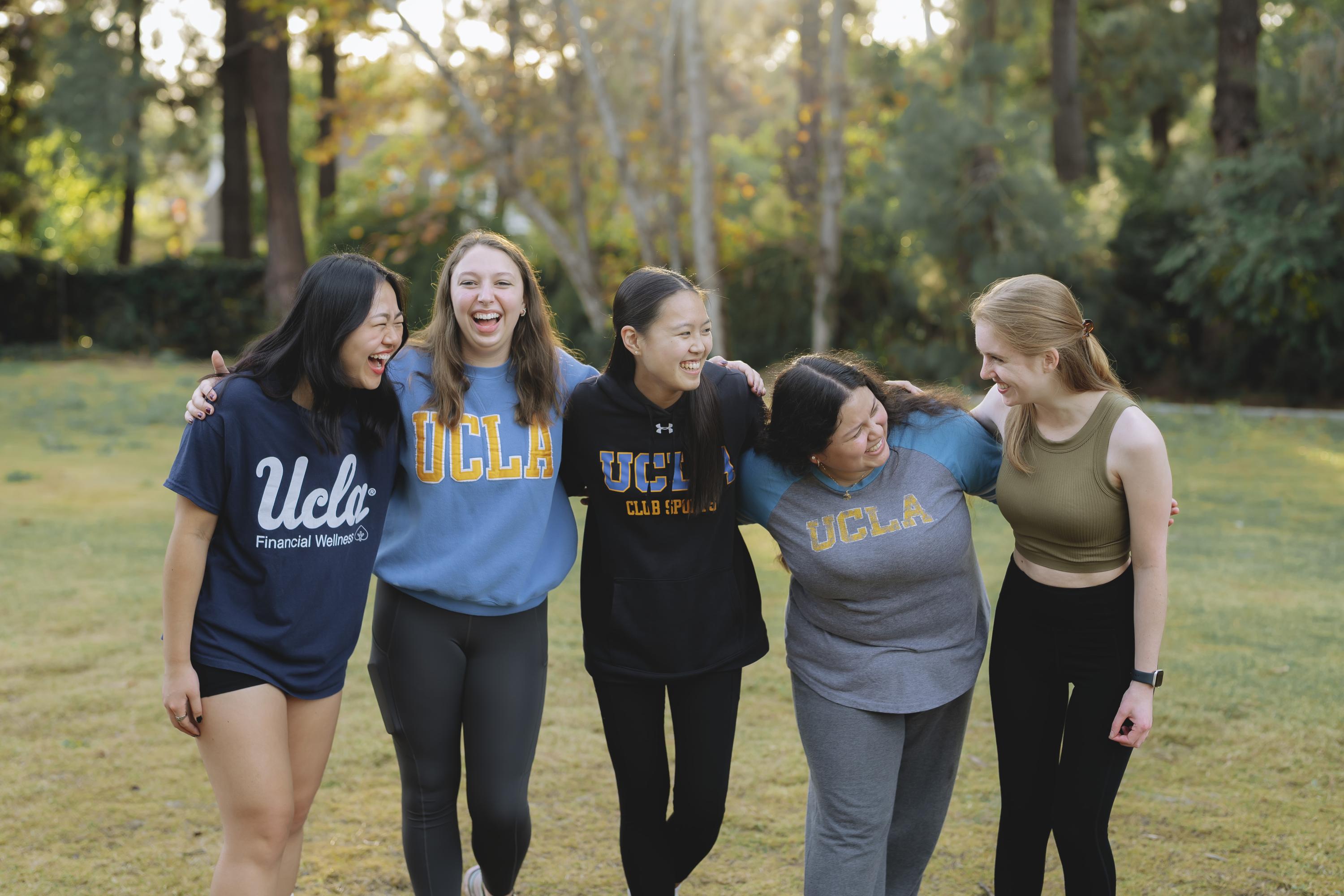 students standing together laughing on a field